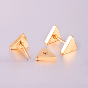 Detailed view of gold triangle stud earrings showing the screw back and components