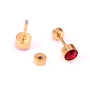 Detail of red cubic zirconia stud earrings with golden screw back closure design