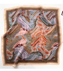 Detailed flat lay of an oil painting style silk scarf with abstract orange and blue patterns