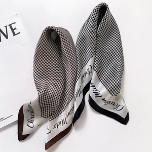 Classic houndstooth silk scarf set in brown and black styles on fashion magazine