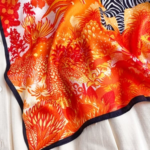 Close-up of tropical silk scarf showing vibrant jungle patterns and zebra stripes
