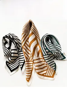 Detail of silk square scarf featuring geometric stripes and fine edge stitching textures