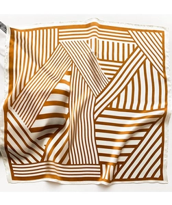 Detailed view of the smooth satin texture and geometric stripe pattern of the silk-like scarf