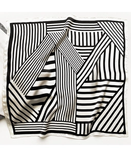 Detail of classic black and white striped silk scarf with smooth texture and neat stitching