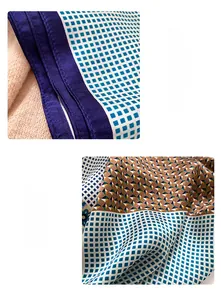 Detailed close-up of square silk scarf showing geometric patterns and neat machine hem edge