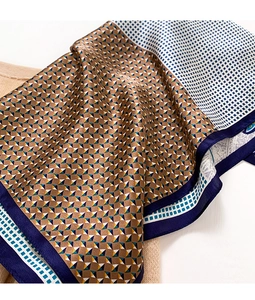Detail of silk scarf with geometric triangle print and deep blue border texture
