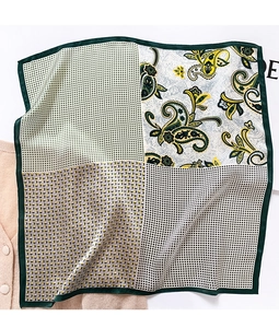 Detailed view of mulberry silk scarf with paisley and geometric patterns on knitwear