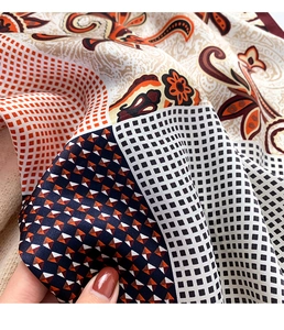 Macro shot of paisley and geometric pattern silk scarf with a soft glossy texture