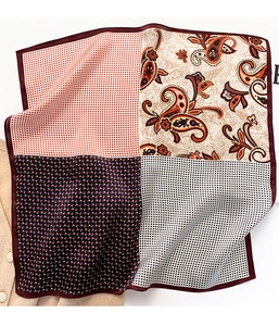 Detail of silk square scarf showing paisley, checkered, and geometric pattern patchwork