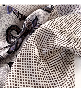 Detailed macro view of mulberry silk scarf with purple paisley and brown check patterns