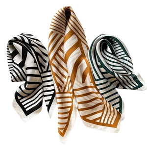Classic striped silk-like scarf with modern geometric patterns in black gold and green