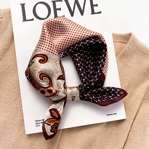 Elegant mulberry silk square scarf with paisley and geometric patterns on a beige knit