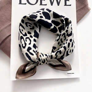 Fashionable leopard print silk scarf with brown border in an elegant bow knot style