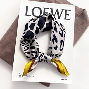 Fashionable leopard print silk scarf featuring yellow and brown color-blocking accents