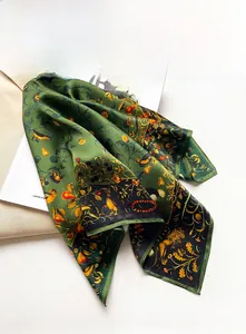 Detail view of vintage dark green silk scarf with artistic floral and animal prints