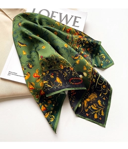 Detailed macro view of vintage silk scarf featuring golden lion and nature motifs