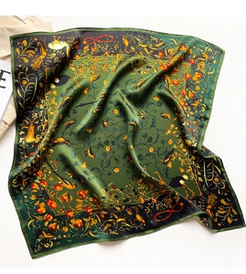Detail of silk scarf showing vibrant bird and floral print on dark green fabric