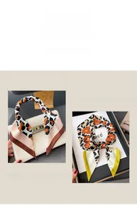 Detailed view of leopard print silk scarf wrapped on a white handbag handle as accessory