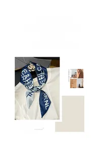 Close-up of narrow silk scarf with letter prints and decorative camellia brooch detail