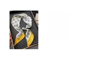 Detail of skinny silk scarf featuring cartoon rabbit patterns and digital print texture