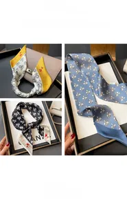 Close-up of three skinny silk scarves with floral and heart patterns for handbag styling