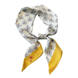 Gray silk scarf with floral patterns and yellow heart edge detail in a tied display