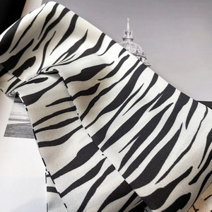 Détail du foulard en satin à motif zèbre montrant le tissage sergé et le brillant