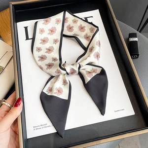 Elegant floral narrow scarf twilly with tulip patterns on a minimalist flat lay background