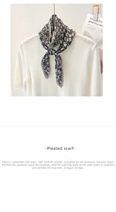 Close-up of pleated floral silk scarf with geometric patterns in 100x130cm size