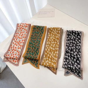 Detail of four floral pleated skinny scarves showing delicate texture and vibrant patterns