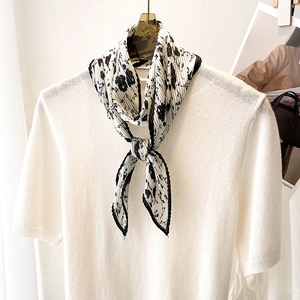 Foulard plissé à fleurs sur haut en tricot blanc avec motif floral noir élégant