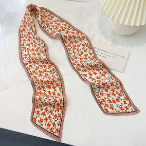 Close-up of floral pleated twilly scarf with vibrant orange flowers and pink edges