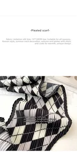 Close-up of black and white checkered pleated silk scarf showing textured fabric detail