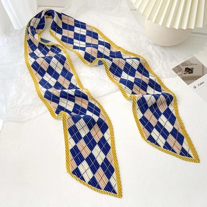 Detail of blue and beige checkered pleated skinny scarf with yellow wavy edges
