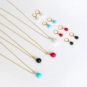 Detailed set of teardrop shell pearl necklaces and hoop earrings in four vibrant colors