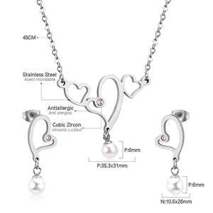 Detail of stainless steel heart necklace and earrings with pearls and zircons