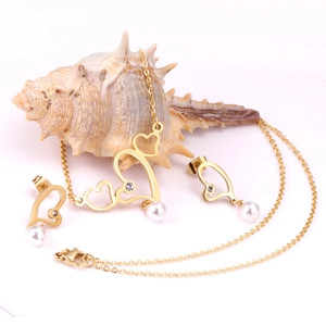 Golden heart-shaped jewelry set with necklace and earrings featuring pearls and zircons
