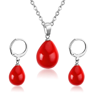 Detail of red teardrop shell pearl necklace and earrings set in stainless steel
