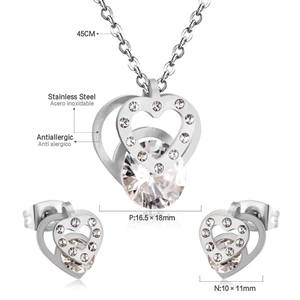 Detailed view of stainless steel heart necklace and earrings set with cubic zirconia stones