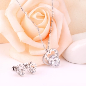 Detailed view of silver heart-shaped necklace and earring set with shimmering cubic zirconia