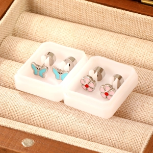 Mini stainless steel stud earrings set featuring blue butterfly and pink flower designs