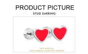 Macro shot of silver-tone stainless steel heart stud earrings with bright red inlay
