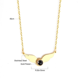 Detail of gold-plated angel wing pendant with 45cm chain and black stone projection