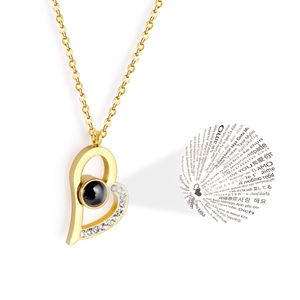Detailed view of gold heart projection necklace displaying I Love You in 100 languages