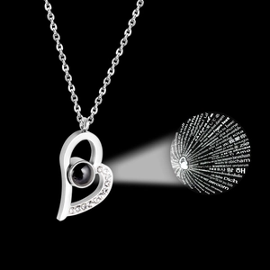 Macro view of heart-shaped projection necklace with clear crystal accents in silver