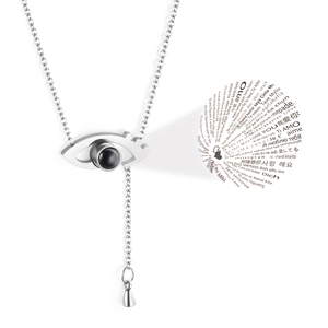 Macro shot of silver projection necklace showing I Love You in 100 languages detail