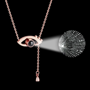 Detail showing rose gold necklace with I Love You projection in 100 languages