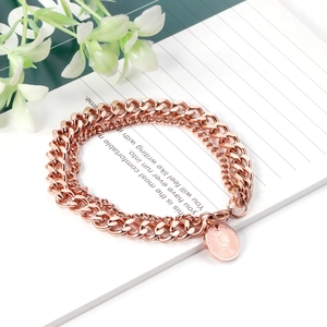 Dettaglio del bracciale a doppia catena groumette oro rosa con ciondolo moneta Regina