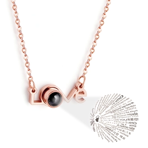 Rose gold LOVE projection necklace showing I Love You in 100 languages for couples
