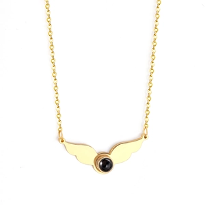 Golden wing heart pendant necklace with black projection stone on white background